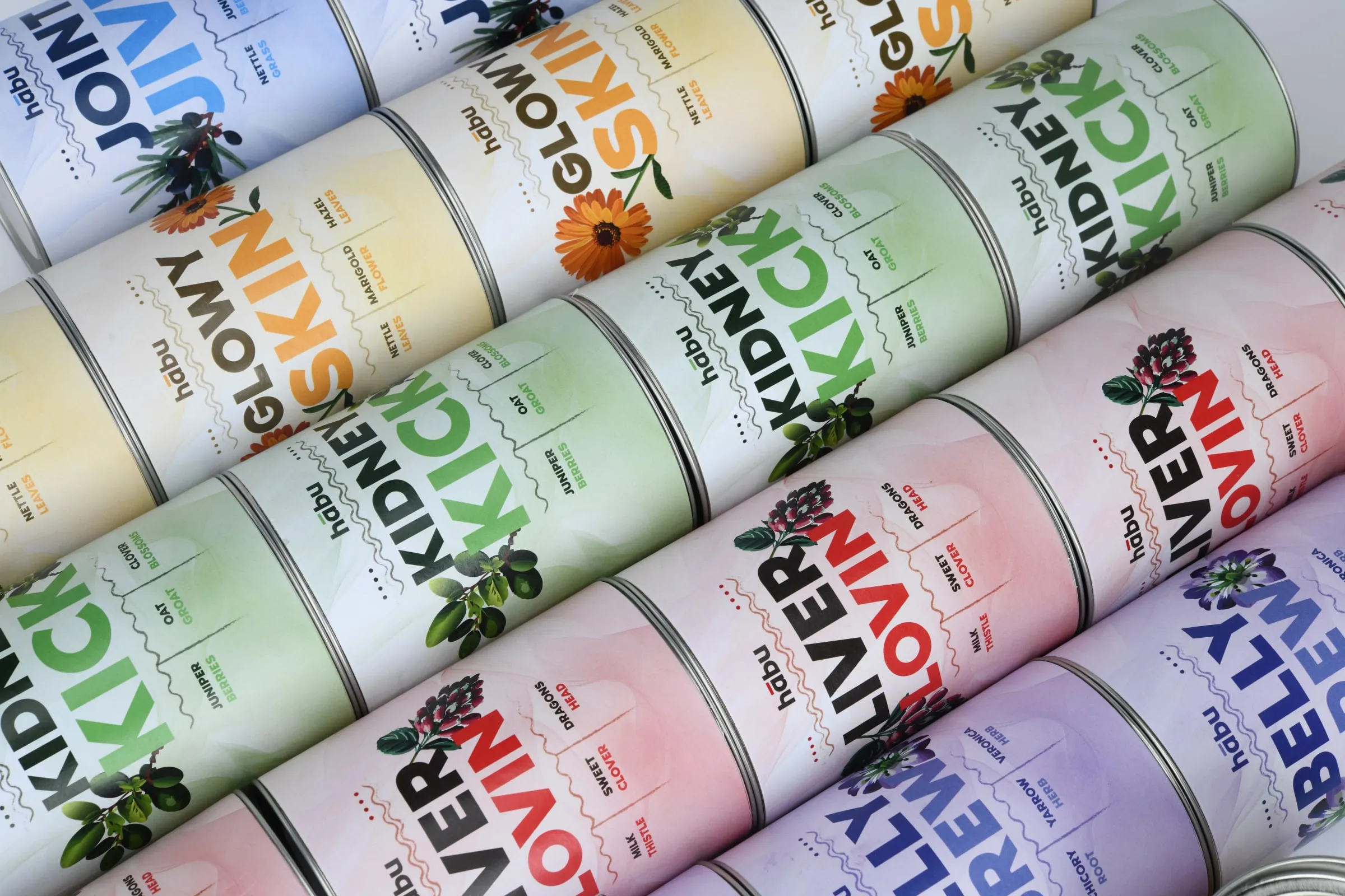 Rows of Habu tins laid diagonally, the labels repeating in green, pink, yellow, lilac and blue.
